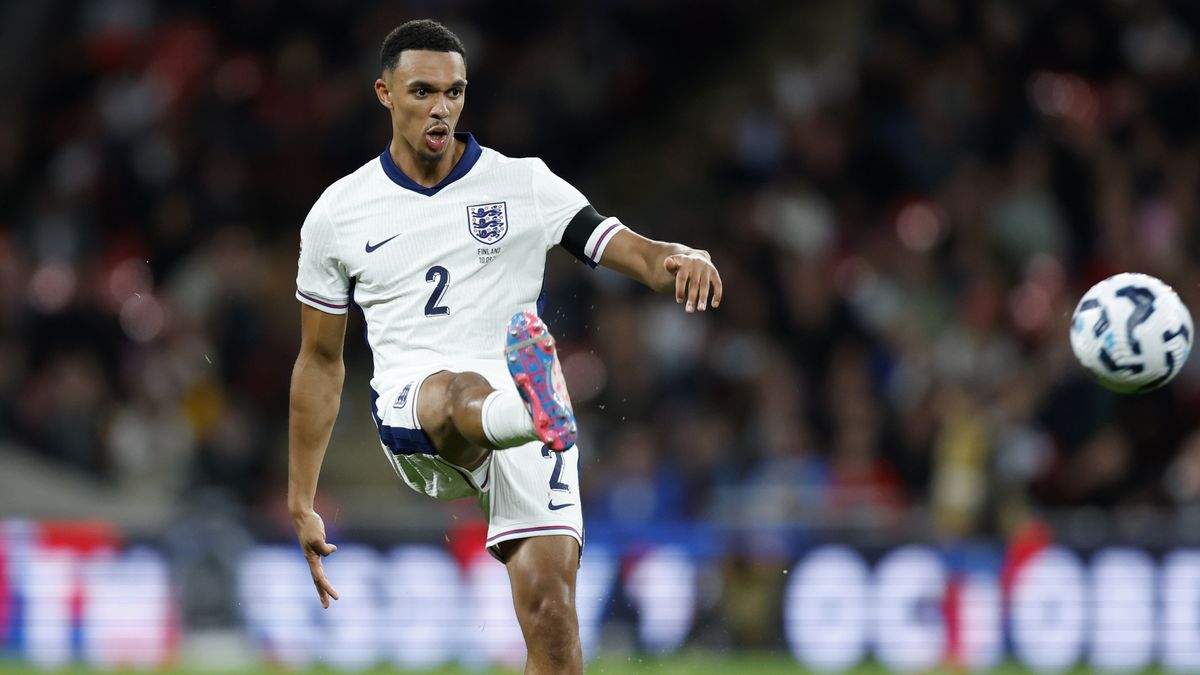 Trent Alexander-Arnold kicks a football in his all white England strip.