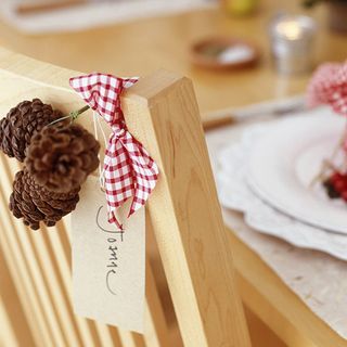 hand made dining chair pine cones and ribbon