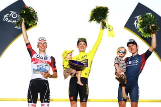 PARIS FRANCE JULY 24 LR Second classified Tadej Pogacar of Slovenia and UAE Team Emirates race winner Jonas Vingegaard Rasmussen of Denmark and Team Jumbo Visma with his daughter Frida and third classified Geraint Thomas of The United Kingdom and Team INEOS Grenadiers with his son pose on the podium during the medal ceremony after the 109th Tour de France 2022 Stage 21 a 1156km stage from Paris La Dfense to Paris Champslyses TDF2022 WorldTour on July 24 2022 in Paris France Photo by Michael SteeleGetty Images