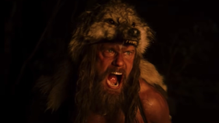 Alexander Skarsgard's Amileth wears a bear's head and screams in the dark in 'The Northman.'