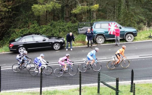 The break receives some spectator encouragement on a climb.