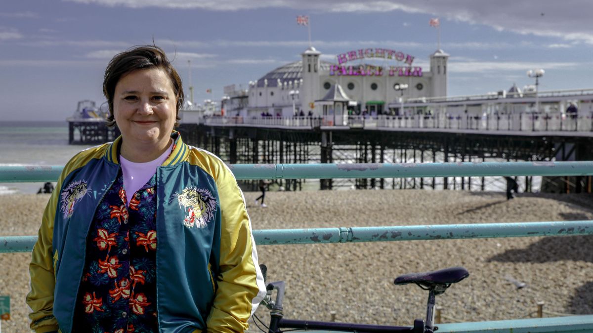 Susan Calman&#039;s Grand Week By The Sea: Susan stands on the Brighton seafront, with Brighton Palace Pier in the distance behind her