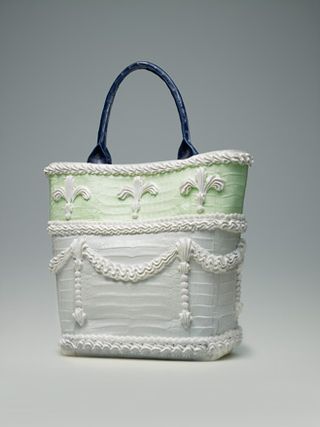 White bag with black handle and ornate decoration