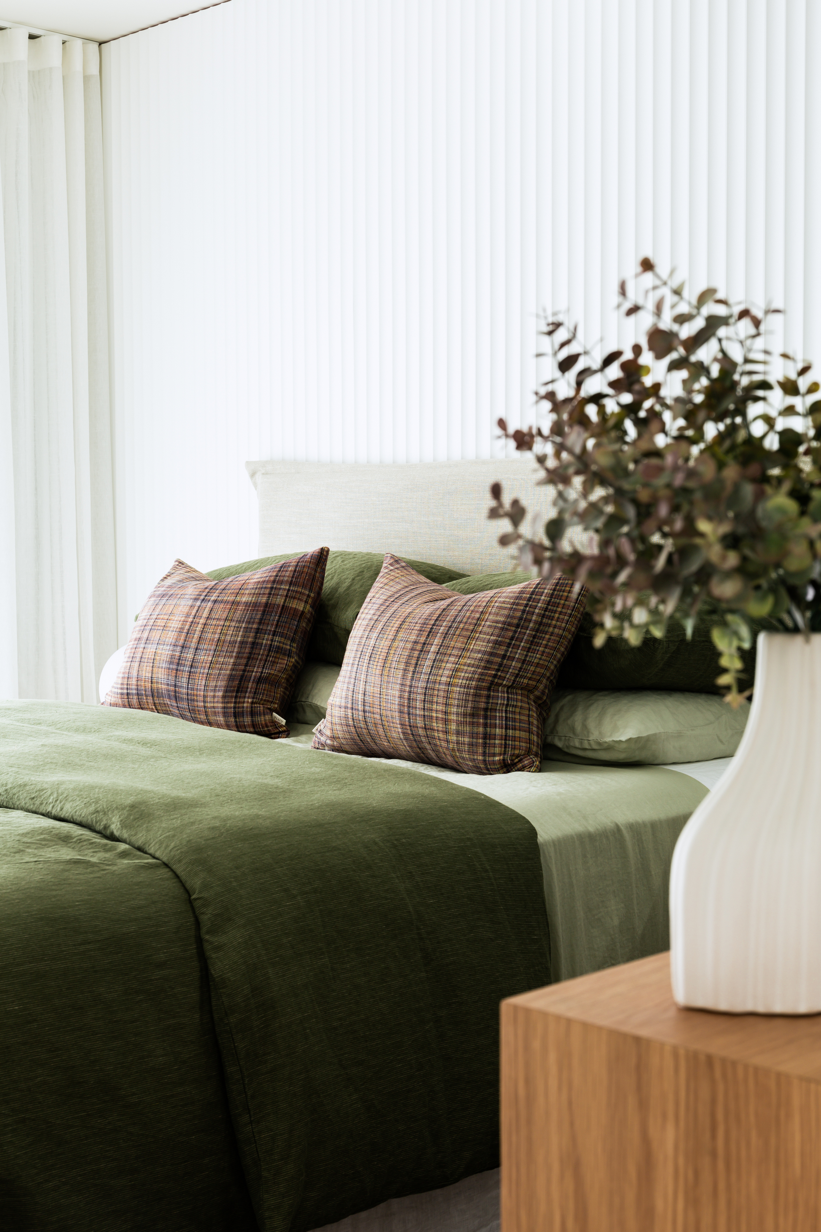 A bedroom with olive green and white walls