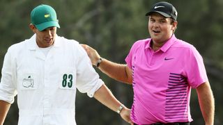 Kessler Karain and Patrick Reed celebrate after Reed wins the 2018 Masters
