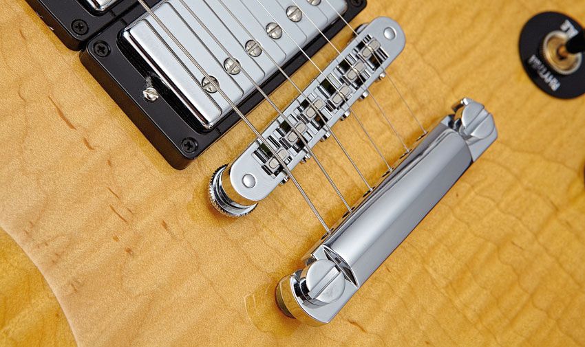 The Supra uses a Fishman Powerbridge with its own battery and preamp in the back of the guitar