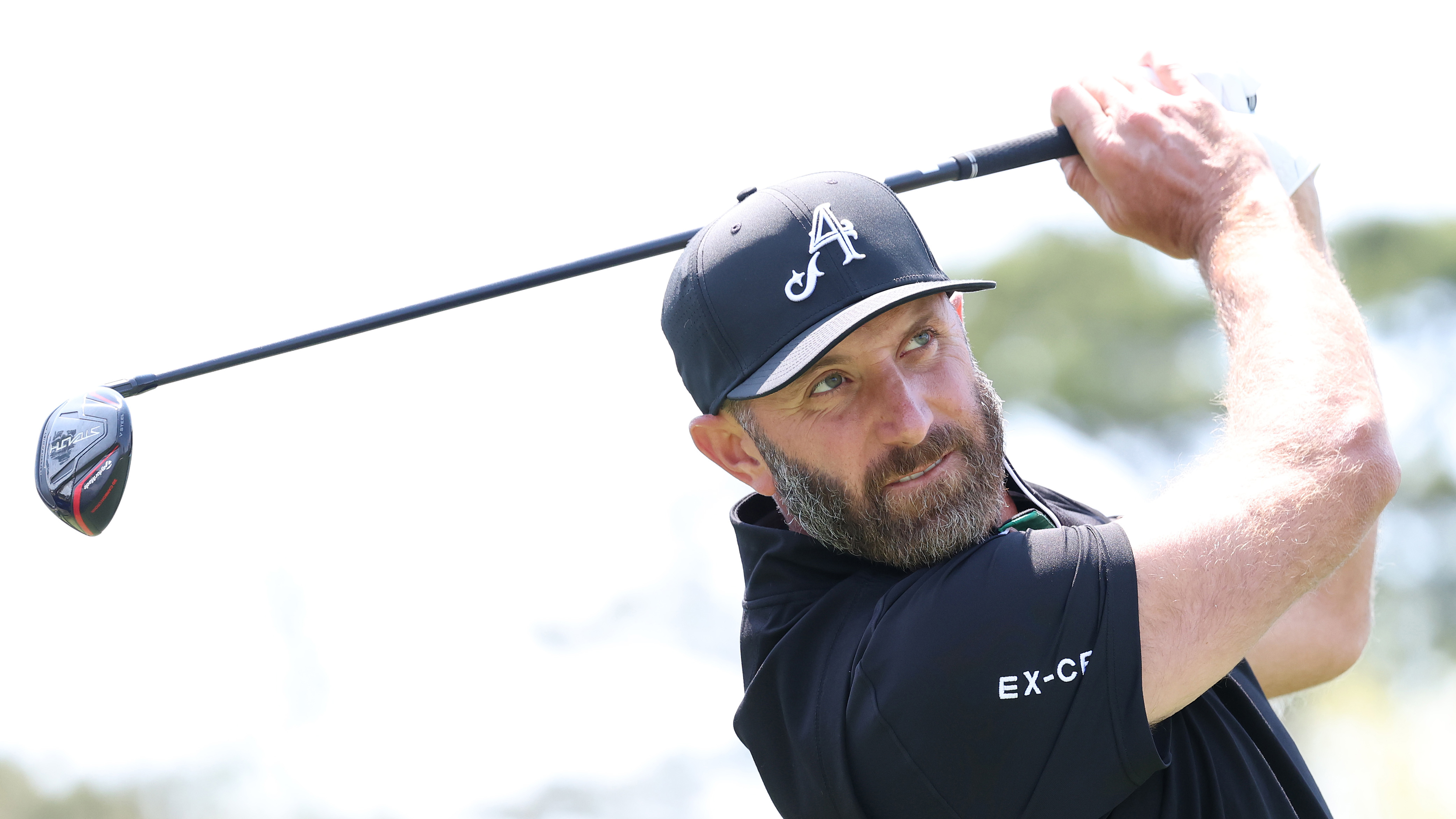 Photo of Dustin Johnson hitting a fairway wood