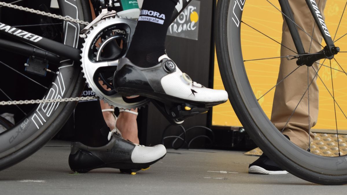 Emanuel Buchmann (Bora-Hansgrohe) cuts out sections of his shoes to prevent any pressure points on his feet