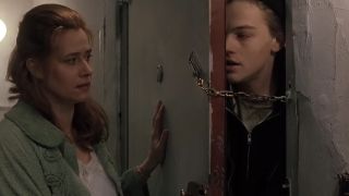 Leonardo DiCaprio looking desperate and trying to get through a door that is locked with a chain