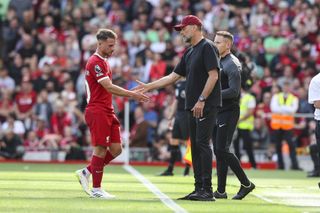 A dejected Alexis Mac Allister shakes hands with Liverpool manager Jurgen Klopp following his red card against Bournemouth in August 2023.