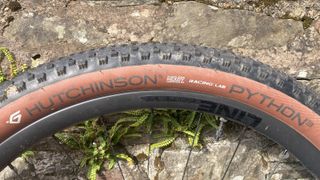 Hutchinson Python 3 Racing Lab fitted to a wheel and against a stone wall