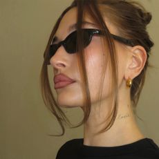 a portrait of hailey bieber wearing sunglasses.