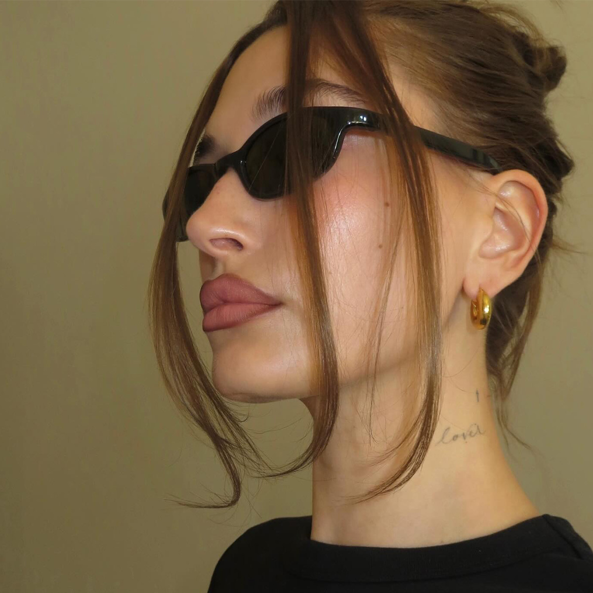 a portrait of hailey bieber wearing sunglasses.