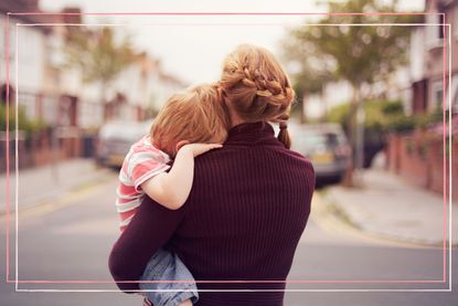 single parent holding her child, looking away from the camera