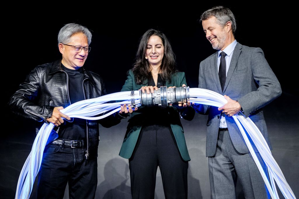 King Frederik X of Denmark (R), CEO and founder of Nvidia Jensen Huang (L), and CEO of the Danish Centre for AI Innovation A/S, Nadia Carlsten (C), symbolically switch on the new AI supercomputer named Gefion at the Vilhelm Lauritzen Terminal in Kastrup, Denmark, on October 23, 2024