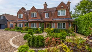 front garden driveway design with gravel landscaping and planting