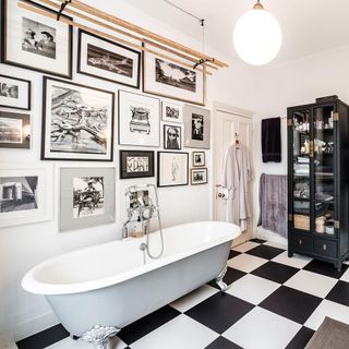 bathroom with black and white photo frame on wall and white bath tub