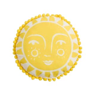 A round yellow cushion with the sun's face on