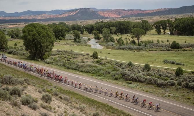 The peloton passes through the wide-open Utah countryside.