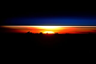 Dome of the sun rises over Earth horizon
