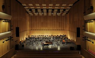 The main auditorium of the second building is a radical construction that combines a fully adaptable, 944-seat space that can be transformed from a symphonic hall to a full proscenium theatre.