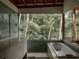 casa quinta by arquipelago, a wooden house on stilts above the rainforest canopy engulfed in greenery and open to nature