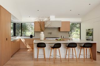A minimalist kitchen with a soffit covering the gap between cabinets and ceiling