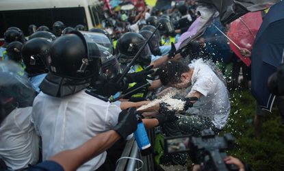 Hong Kong police fire tear gas and pepper spray into a crowd of demonstrators
