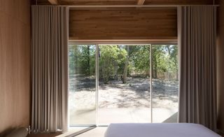 wooden bedroom with curtains