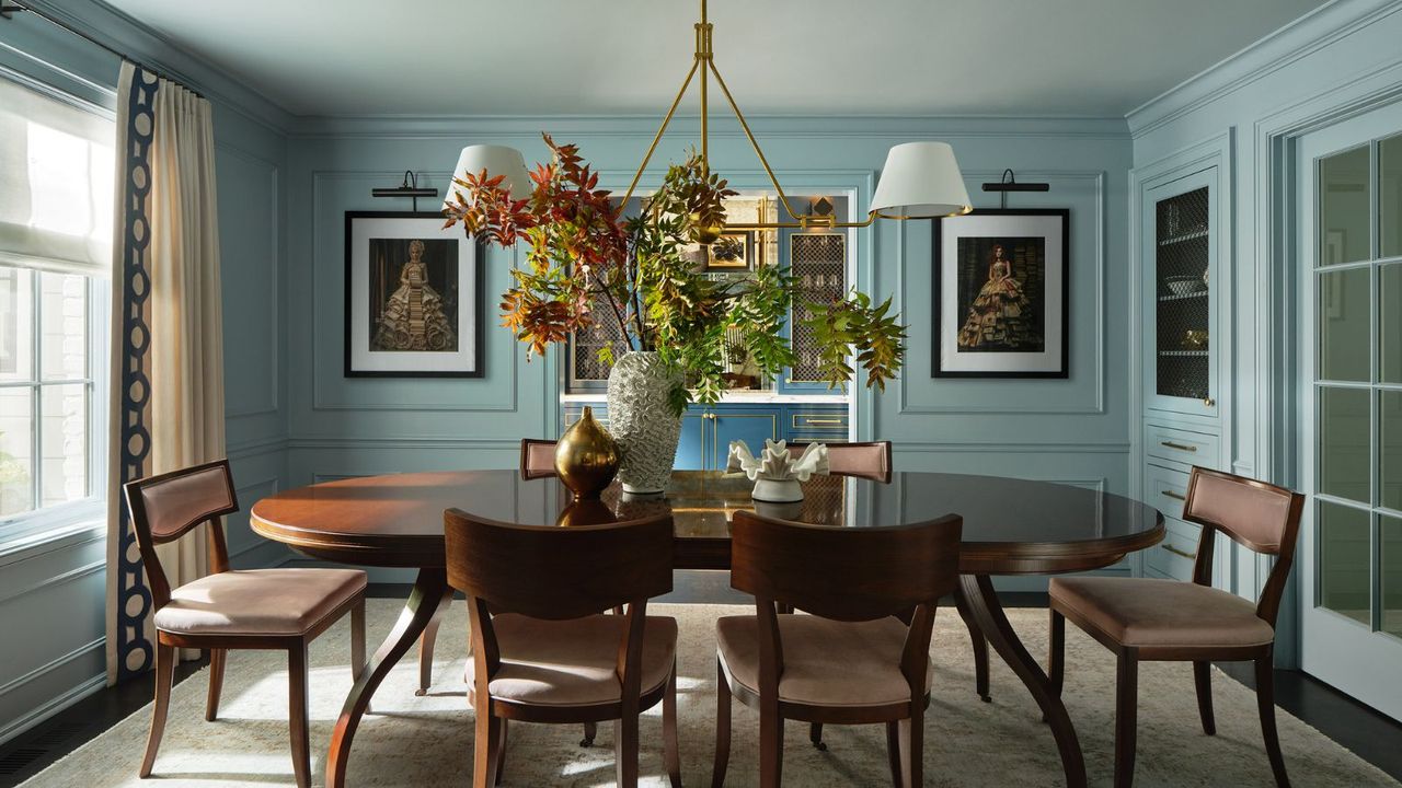 dining room with blue walls, large dark wooden dining table and chairs