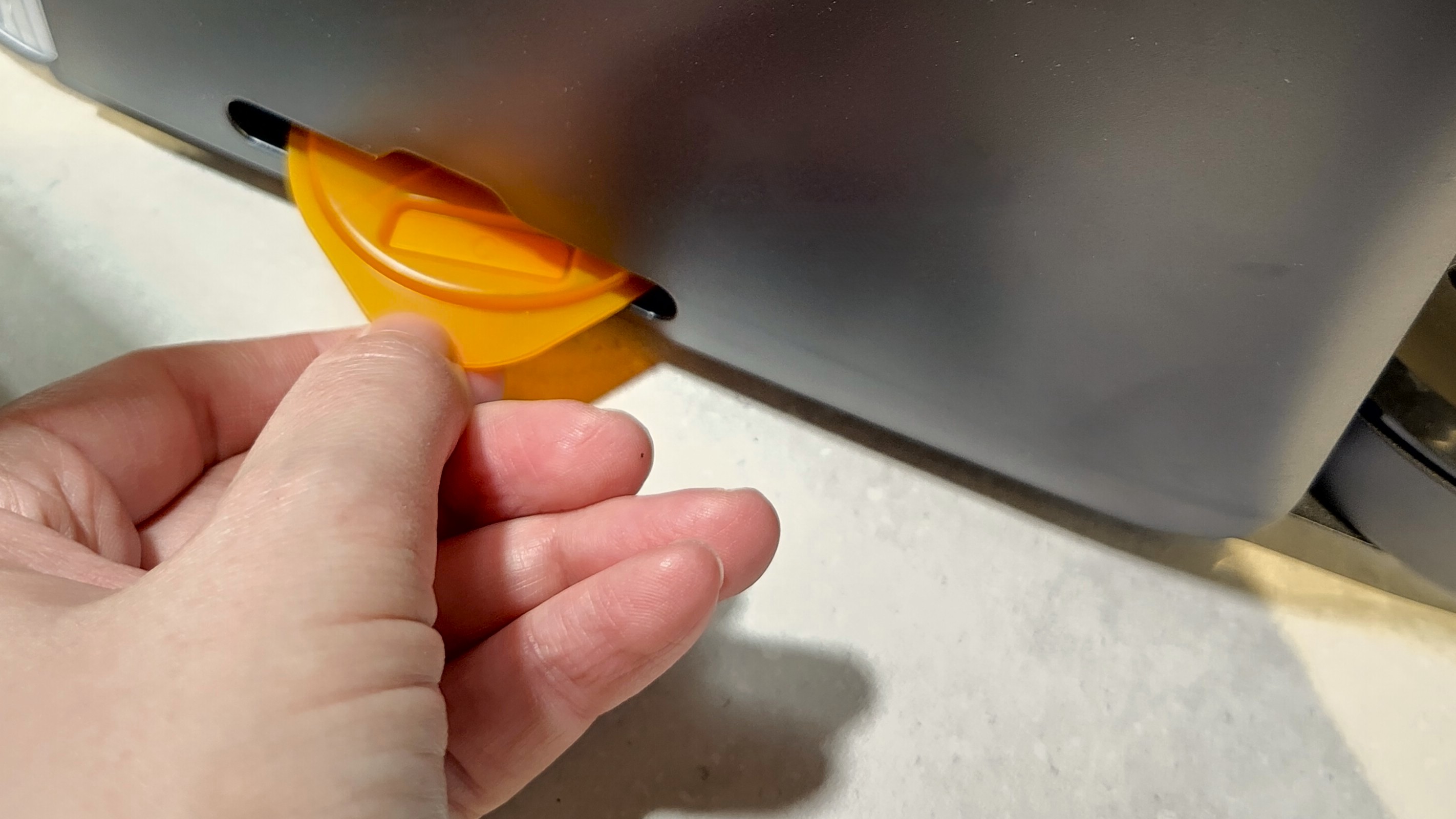 Removing maintenance disc from slot on Tassimo Finesse Friendly coffee maker