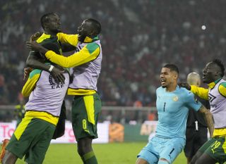 Sadio Mane, top left, celebrates Senegal's victory with Cheikhou Kouyate, centre, and other team-mates