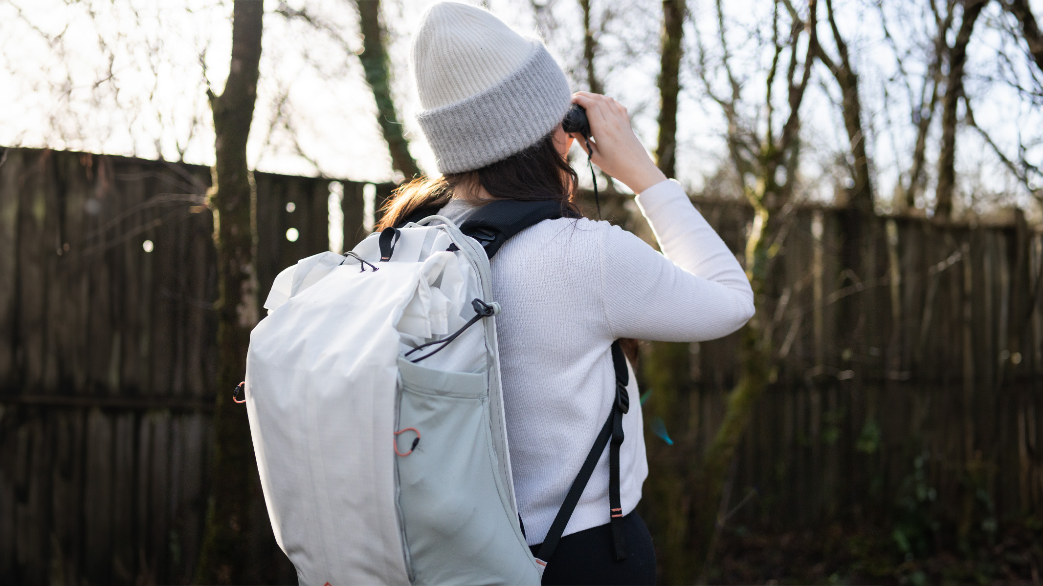 woman wearing the peak design outdoor bag in a nature reserve