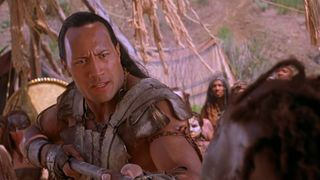 Dwayne Johnson holds a spear against an enemy in The Scorpion King