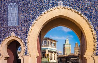 The elaborately tiled Bab Bou Jeloud gate that welcomes visitors to the Medina of Fez in Morocco