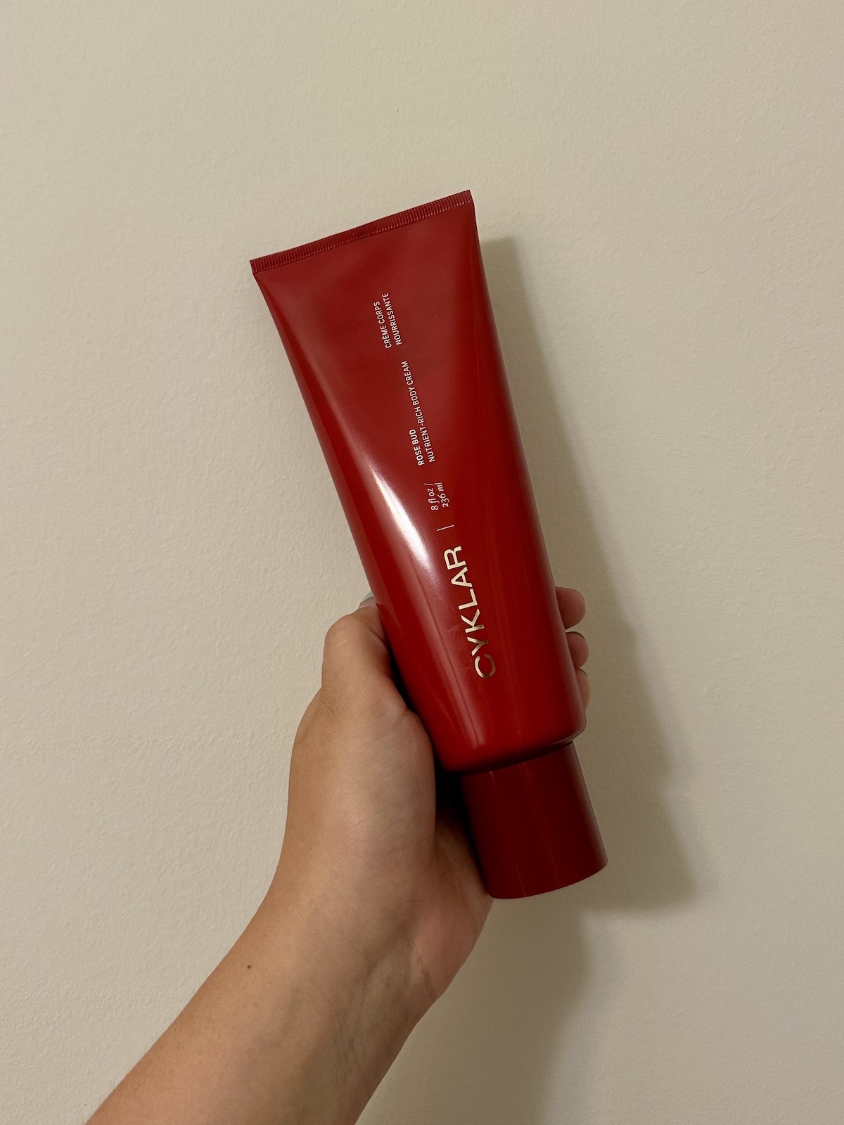 Beauty Editor Kaitlyn McLintock holding Cyklar's Body Cream in Rose Bud