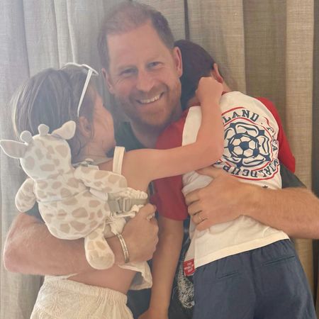 Prince Archie and Princess Lilibet hugging Prince Harry