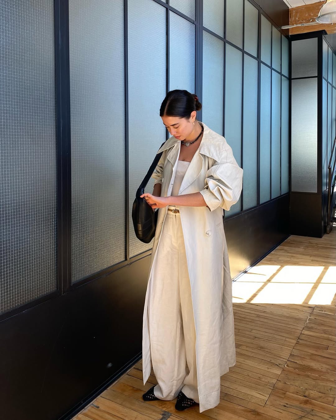 Influencer Sasha Mei wearing wide-leg trousers and ballet flats.