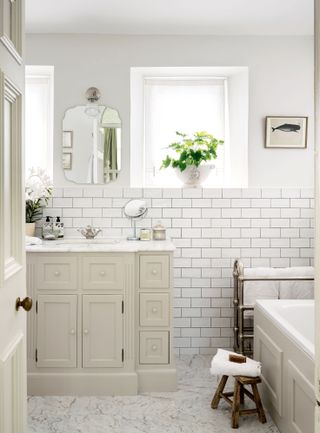 traditional-style bathroom with white metro tiles and vanity unit
