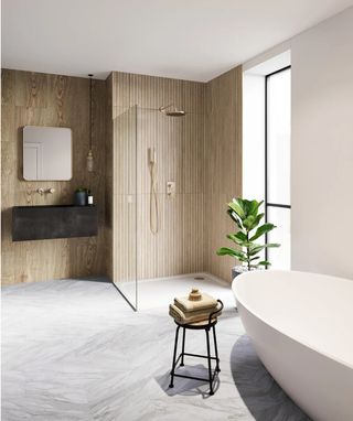 Marble effect floors in a contemporary bathroom with a walk-in shower and freestanding bath