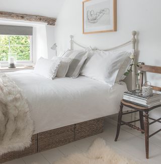 bedroom with white wall and white bedlinen
