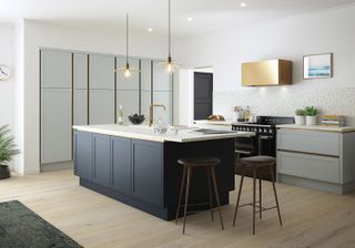 modern shaker kitchen with gold cooker hood and navy island