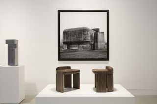 Brown wooden stools with large picture on wall