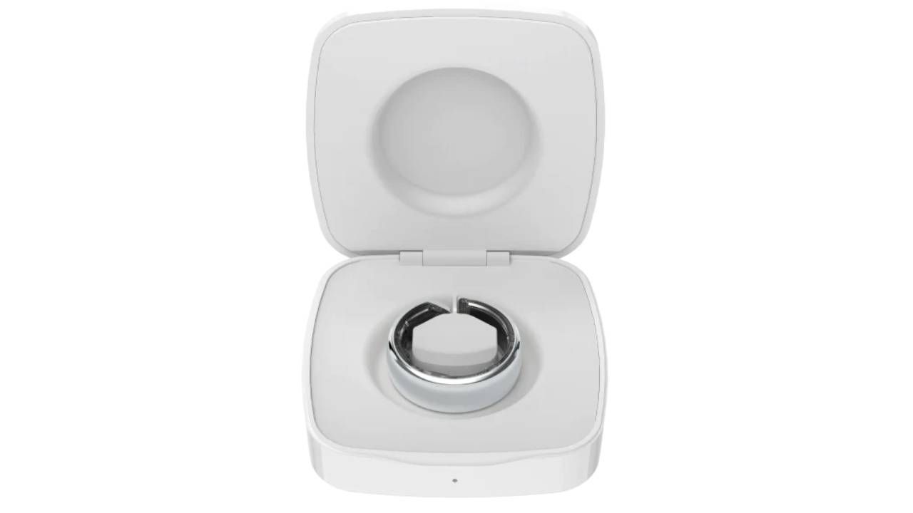 The silver Evie Ring sat in its portable charging case
