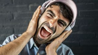 Loudest headphones: Man listening to loud music through his headphones