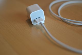 Plugging the Lightning cable into a USB wall adapter
