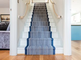 staircase ideas: striped runner coastal style staircase