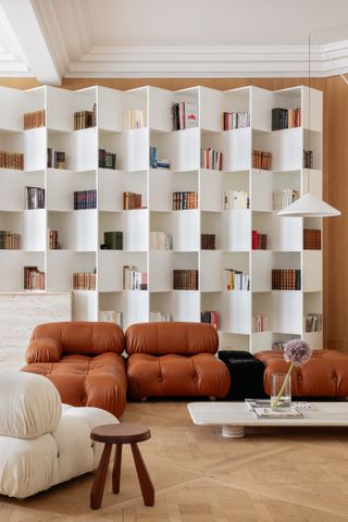 A living room with a sculptural bookshelf