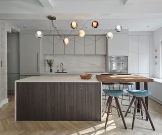 A modern kitchen with porcelain tiles that look like stone used as a backsplash