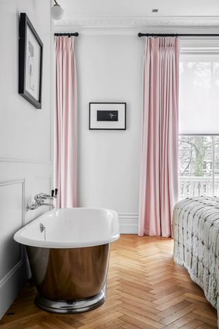 Copper freestanding bath in modern bedroom